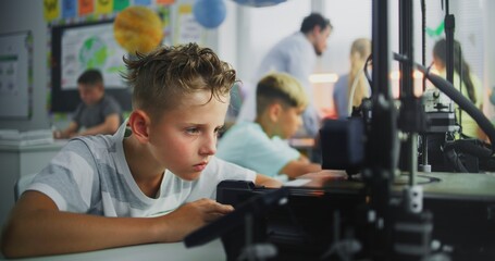 Talented Young Boy Using 3D Printer Touchscreen, Studying Advanced Automated 3D Printing. Primary School Student During Engineering and Programming Lesson in Classroom. Interactive STEM Education.