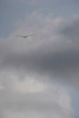 A glider being towed into the sky by a winch