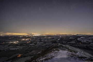 Drone aerial view of the Shropshire landscape at night in winter, with countryside and village lights