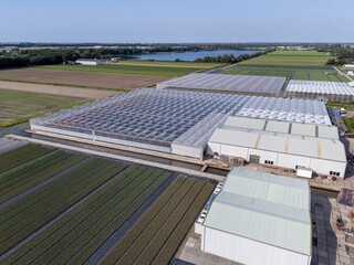 Aerial view of greenhouse complex and fields.