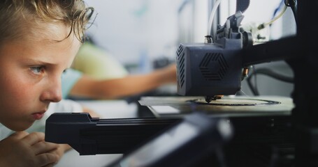 Close Up of Elementary School Boy Using 3D Printer Touchscreen, Learning Advanced Automated 3D Printing During Programming Lesson. Smart Young Boy Studying Technology. Interactive STEM Education.