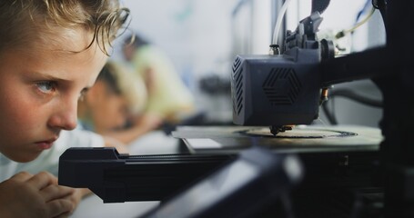 Close Up of Elementary School Boy Using 3D Printer Touchscreen, Learning Advanced Automated 3D Printing During Programming Lesson. Smart Young Boy Studying Technology. Interactive STEM Education.