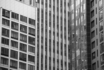 empty glass windows of a modern building with a reflection of the sky in the glass
