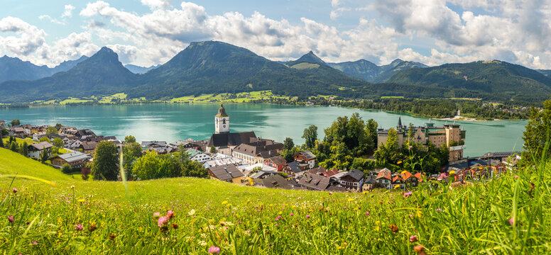 Sankt Wolfgang on Lake Wolfgangsee, panoramic view from a meadow of the landscape with the town, lake, and mountains, Austria