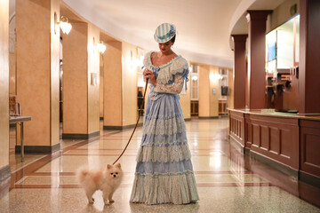 Elegant woman with Pomeranian dog in luxury interior