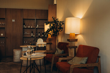 Stylish lounge area with wooden furniture and warm lighting in a modern café
