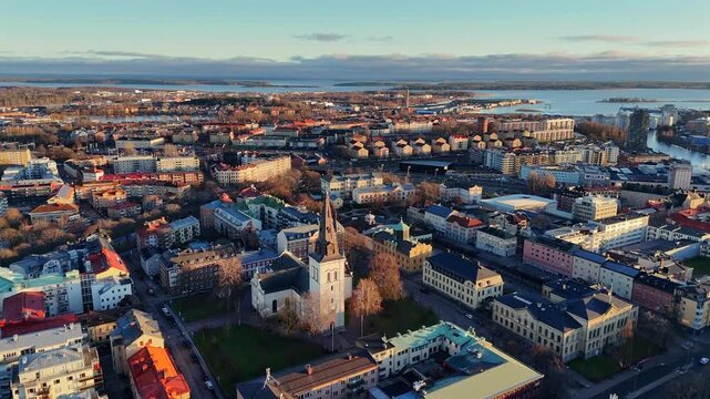Aerial close up view of Karlstad Cathedral surrounded by colorful city buildings and streets in daylight 