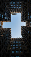 Skyscrapers Perspective: Capturing a low-angle view of the towering skyscrapers, creating a compelling pattern with their window and the blue sky above.
