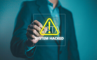 Cybersecurity concept showing businessman pointing at a warning sign with System Hacked text, symbolizing data breach, cyber attack, and security risk in modern digital systems.