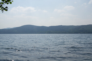 A calm lake with a clear blue sky above it