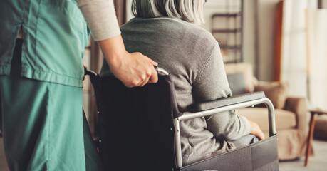 Healthcare worker with elderly patient in wheelchair