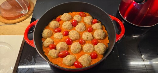 frying pan with meat balls and tomatoes