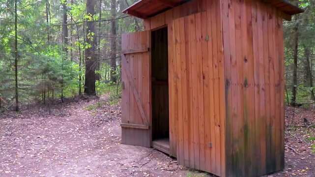Outhouse wooden house in the forest National Park Belarus.