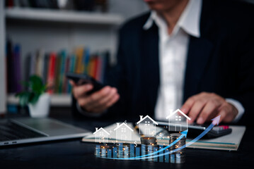Real estate investor using a smartphone to track property growth and financial progress, with digital graphics showing increasing property values and profits.
