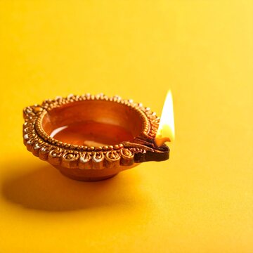 festival of lights oil lamp or diwali diya on yellow background