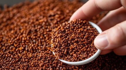 Small white bowl holding finely ground, reddish-brown spice