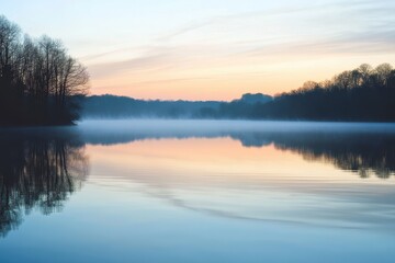 Fototapeta premium Serene Lakeside Sunrise: A Tranquil Morning Scene with Mist and Reflections on Calm Waters