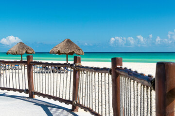 Tropical beach in Cancun in Mexico with turquoise sea water scenic landscape. Luxury resort on Playa del Carmen Caribbean resort. Sea view from hotel to the beach