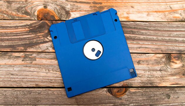 A blue 3.5-inch floppy disk rests on a rustic wooden surface - Powered by Adobe