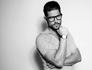 Handsome young and successful business man posing with wirst watch in formal attire