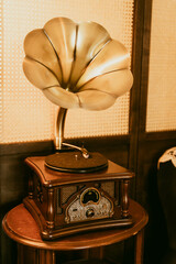 vintage gramophone on old wooden table, warm indoor yellow light
