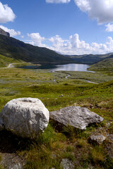 A beautiful landscape with a lake or a pond, trees and mountains. Norway. 