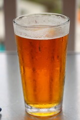 a glass of beer with the blurred background