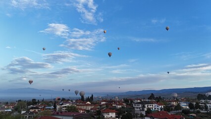 Aerial View of Hot Air Balloons Over Pamukkale Travertines and Town in Turkey