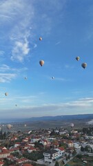 Aerial View of Hot Air Balloons Over Pamukkale Travertines and Town in Turkey
