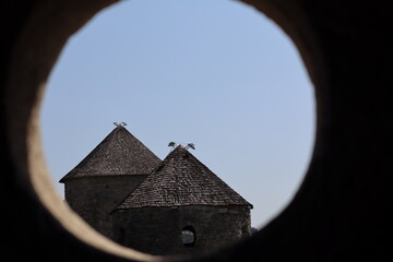 View of historic stone towers framed by an arch showcasing traditional architecture on a clear day