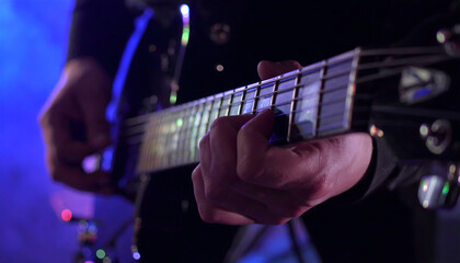 Close-Up of Guitar Strings and Finger on Fretboard with Colorful Bokeh
