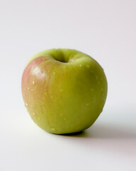 One fresh green apple on a white background
