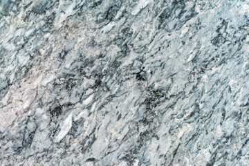 Polished marble surface, natural stone texture with organic lines. Gray marble surface with dynamic black and white veining. Concept of modern natural background