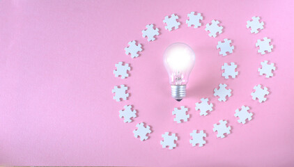 Business concept,collaboration,cooperation,teamwork makes the dream work,idea,communication, innovation,human resources,recruitment,team building. Jigsaw puzzle pieces and light bulb.