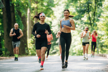 Activity, healthcare conception. Group of runners are together outdoors