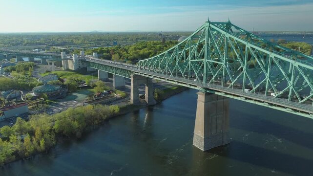 Jacques Cartier Bridge spans the Saint Lawrence River in Montreal, Canada. The bridge facilitates transportation and connects Montreal to the South Shore.