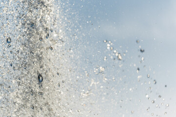 Splashes and jets of water against light background.
