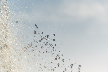 Splashes and jets of water against light background.