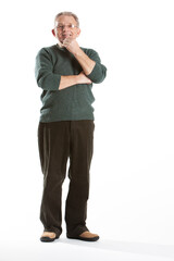 Elderly man with arms crossed. A senior man stands with his arms crossed, looking thoughtfully at the camera. © track5