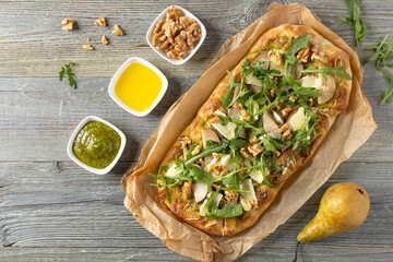 Traditional Roman pinsa with pear, nuts and arugula