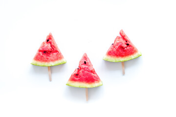 Fresh watermelon on stick for fruit ice cream on white background top view