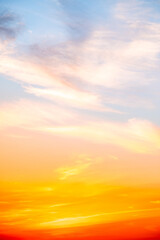Obraz premium Beautiful , luxury soft gradient orange gold clouds and sunlight on the blue sky perfect for the background, take in evening,Twilight, Large size, high definition landscape photo,Vertical
