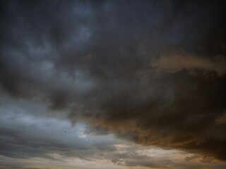 Obraz premium Dramatic panorama sky with storm cloud on a cloudy day. Panoramic image.gllomy sky with dark gray clouds.Aerial view over the dramatic clouds.Dramatic panorama sky with storm cloud on a cloudy day. 