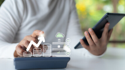 Person using tablet and smartphone to analyze carbon credit investment growth with digital financial icons, concept of sustainable finance, and green economy