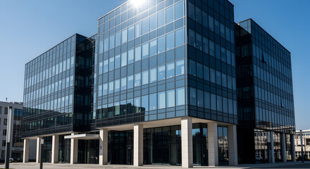 Modern Glass Office Building Exterior Under Clear Blue Sky: Contemporary Corporate Architecture and Urban Business Hub Facade