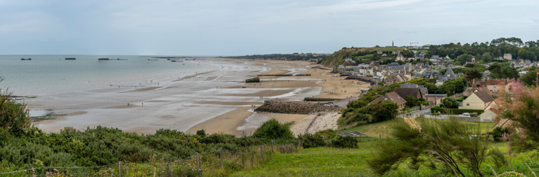 Arromanches-les-Bains, France - 08 08 2025:  Normandy landing blockhouse. Panoramic view of the artificial port, the beach, the sea, cliffs and the city