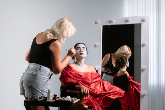 Makeup Artist Applying Stage Makeup to Female Model in Studio
