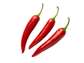 Three vibrant red chili peppers with green stems isolated against a stark black background studio shot