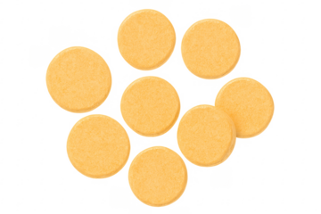 Orange vitamin or supplement pills forming a diamond shape on transparent background