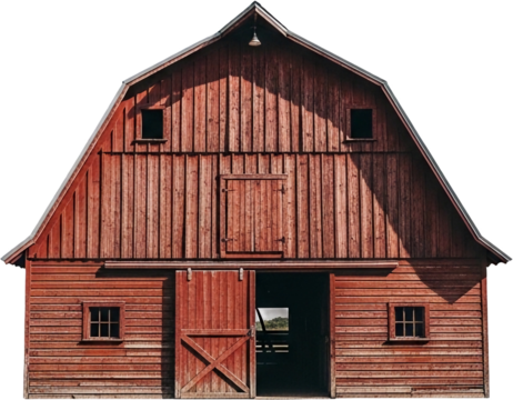 Rustic red barn stands tall under a clear sky in a rural landscape during midday